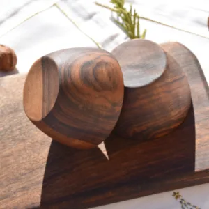 Handmade hand-carved walnut wood bowl with smooth natural texture on neutral background