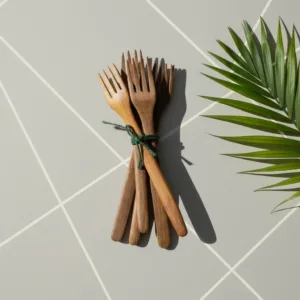 Handcrafted walnut wood fork set with natural grain against neutral studio background